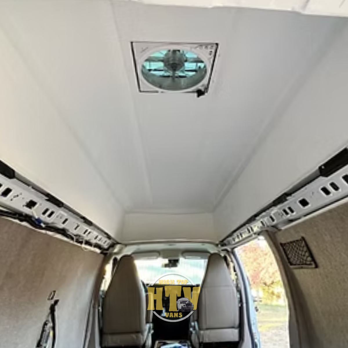 Ceiling of a High Top van with a mounted fan.