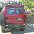 Aluminess rear bumper installed on a Ford E-Series van for off-road and overland use