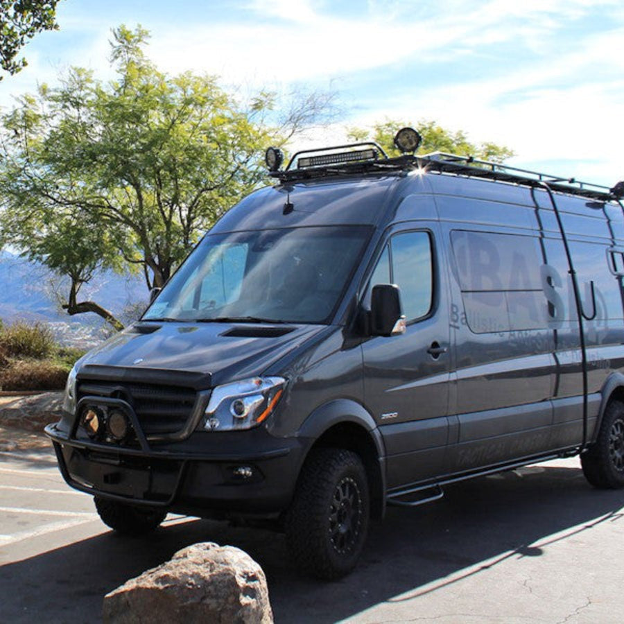 Front receiver hitch visible while Sprinter van is traveling